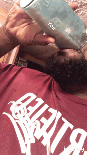 a man drinking from a bottle that says you