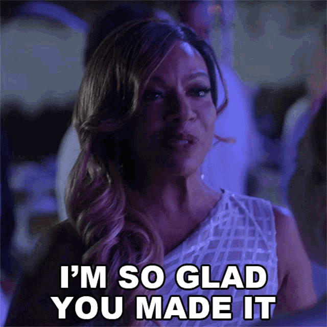 a woman in a white dress is saying i 'm so glad you made it