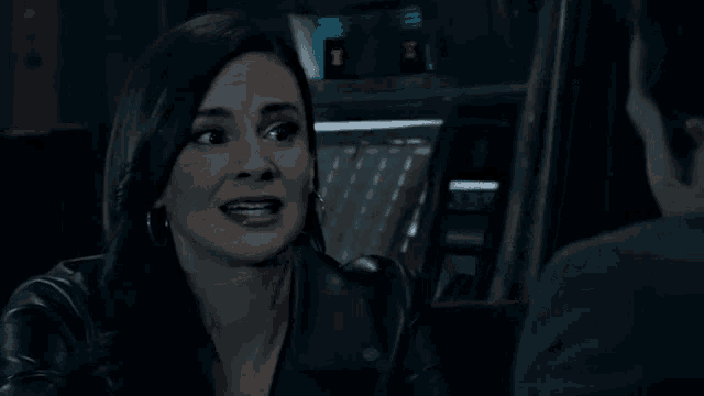 a woman is making a funny face while looking at a man