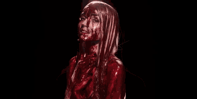 a woman with blood on her face and body is screaming