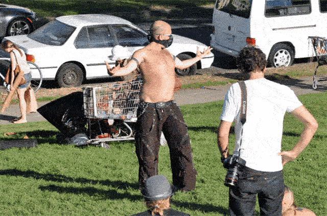 a man wearing a mask is standing in the grass