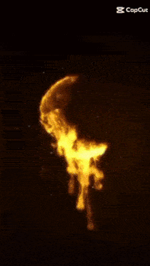 the letter g is surrounded by flames on a dark background