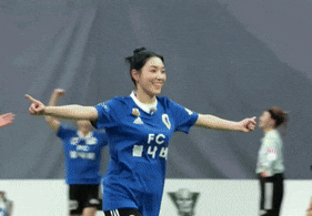 a female soccer player wearing a blue fc jersey