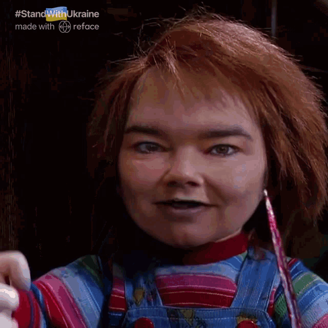 a doll with red hair and overalls that says good guy