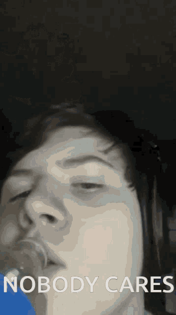 a man with a pacifier in his mouth and the words nobody cares behind him