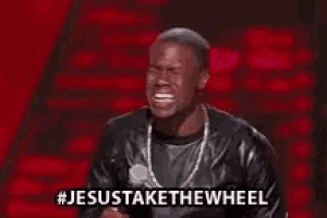 a man in a leather jacket is standing in front of a microphone and says jesus take the wheel .