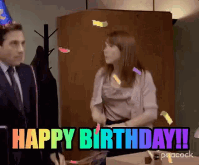 a man and a woman are celebrating a birthday in the office .