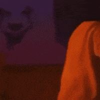 a person walking down a set of stairs at night with a yellow light behind them