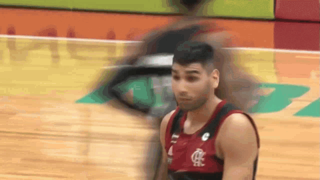 a blurry picture of a basketball player wearing a red and black jersey with the letter r on it