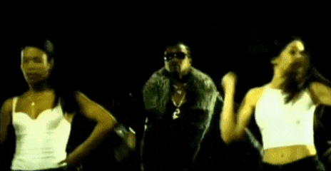 a group of people are dancing in a dark room with a blue light behind them