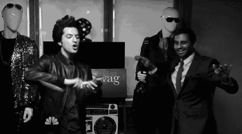 a man in a suit is dancing in front of a nbc sign