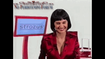 a woman is smiling in front of a screen that says strozus