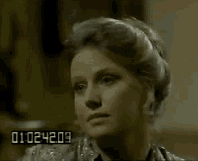 a close up of a woman 's face with the numbers 01 02 44 19 in the corner