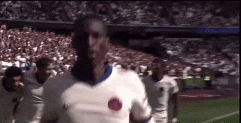 a soccer player wearing a white shirt with a circle on it