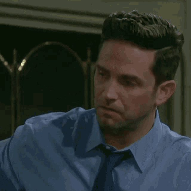 a man is covering his mouth with his hands