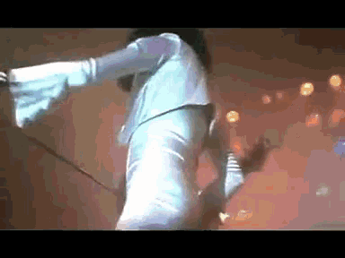 a woman in a blue dress is dancing on a stage .