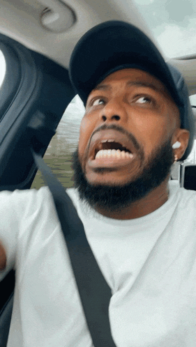 a man with a beard is wearing a black hat