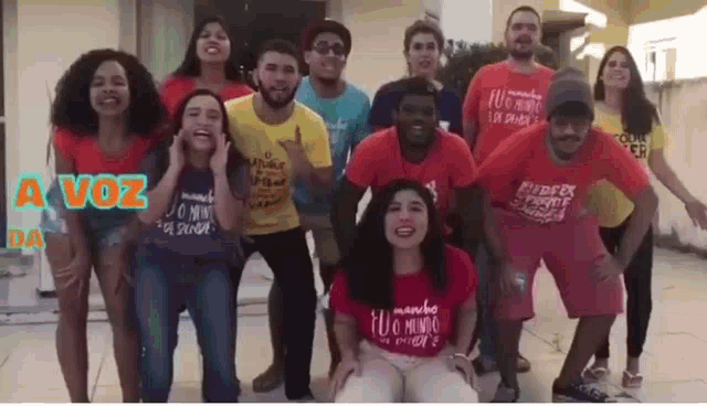 a group of young people are standing next to each other and smiling .