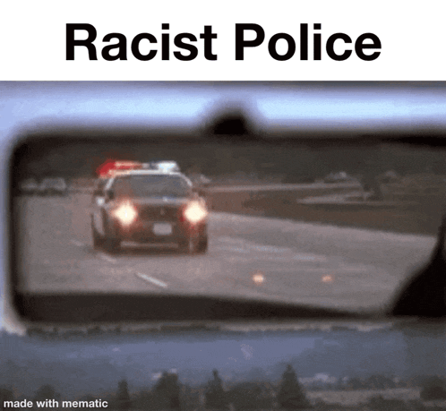 a police car is driving down a highway and is reflected in a rear view mirror .