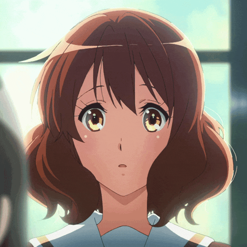 a close up of a girl 's face with brown hair