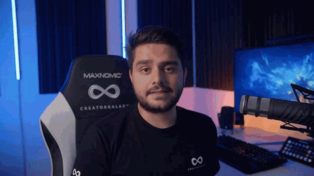 a man sitting in a maxnomic creatorgalaxy chair