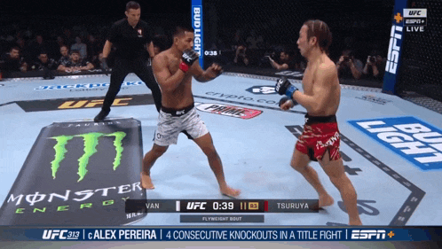two men are fighting in a boxing ring with a monster energy advertisement in the background