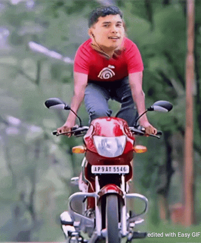 a man is riding a red motorcycle with a license plate that says ap9at 5546