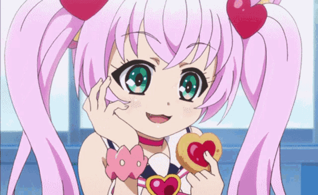 a girl with pink pigtails is holding a heart shaped cookie