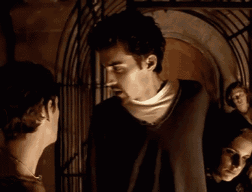 two men are standing next to each other and looking at each other .