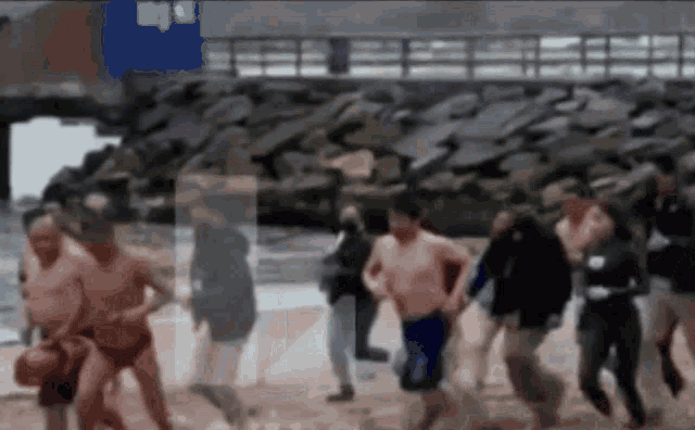 a blurry picture of people running on the beach