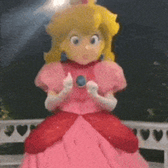 a princess peach mascot is giving a thumbs up .