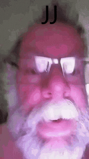 a man with glasses and a beard has the word jj on his head