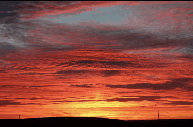a sunset with a lot of clouds and the sun shining brightly