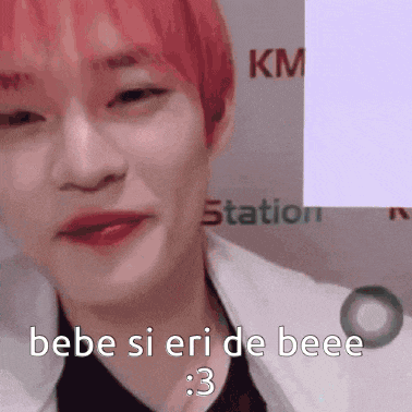 a close up of a person 's face with red hair and the words `` bebe si eri de beee '' written on it .