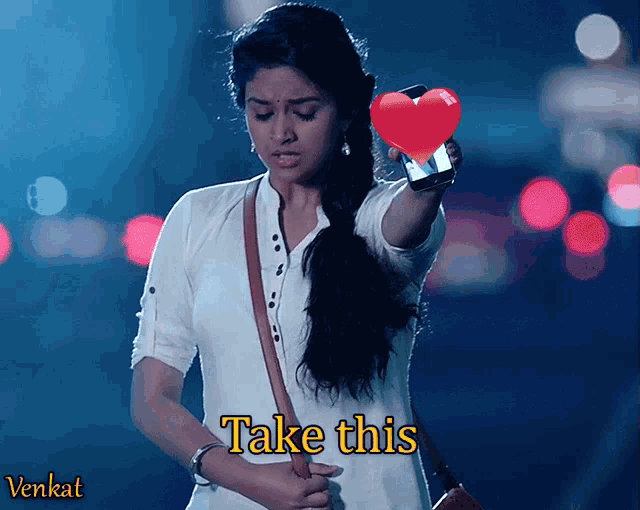 a woman is holding a cell phone with a heart on it and the words take this below her