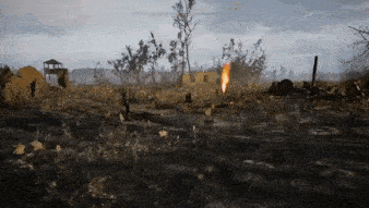 a video game scene of a field with a burning building in the background .