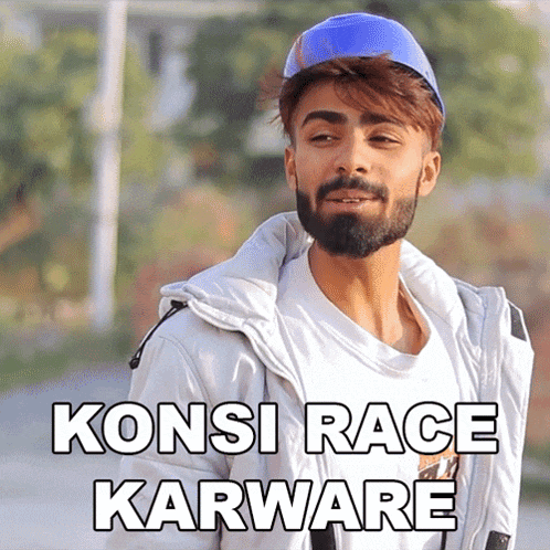 a man with a beard is wearing a white jacket and a blue hat that says koni race karware