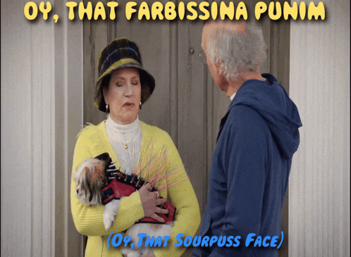 a woman in a yellow sweater is holding a dog and talking to a man in a blue jacket
