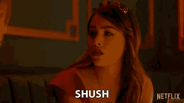 a woman in a red dress is making a face and the word shush is on the bottom right