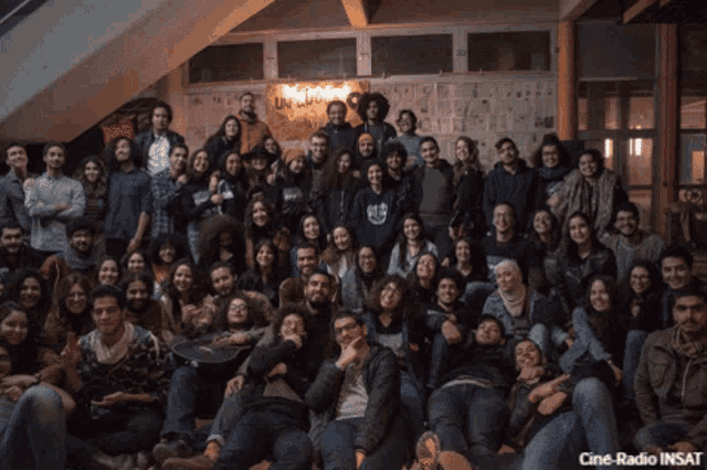 a large group of people posing for a picture with the words cine-radio insat on the bottom