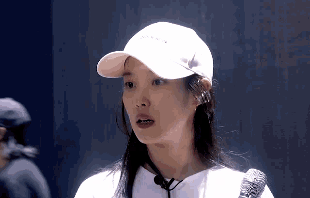 a woman wearing a white hat and a white shirt