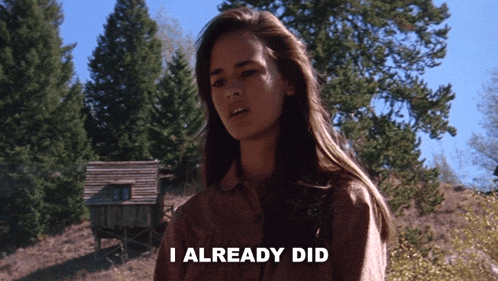 a woman says i already did in front of a wooden house