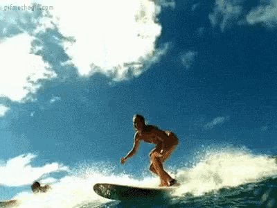 a woman is riding a wave on a surfboard in the ocean