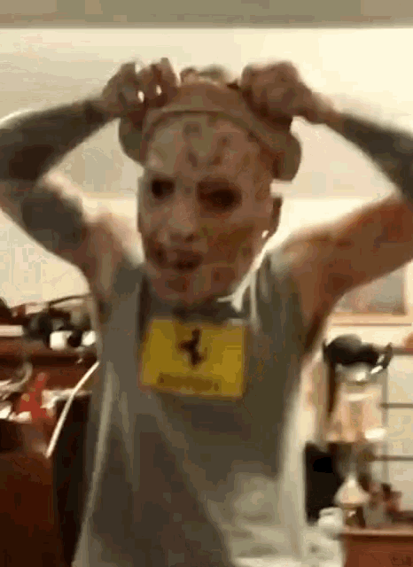a man wearing a mask and a shirt that says ferrari