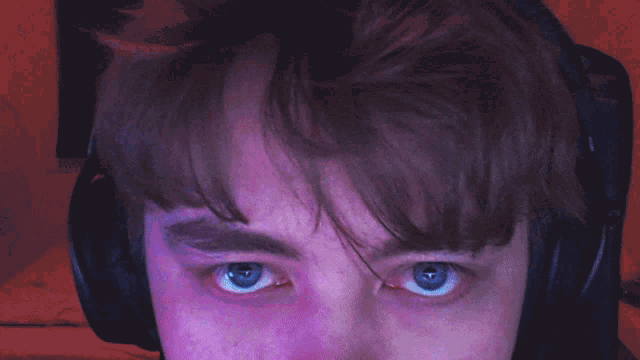 a close up of a person 's eyes with headphones