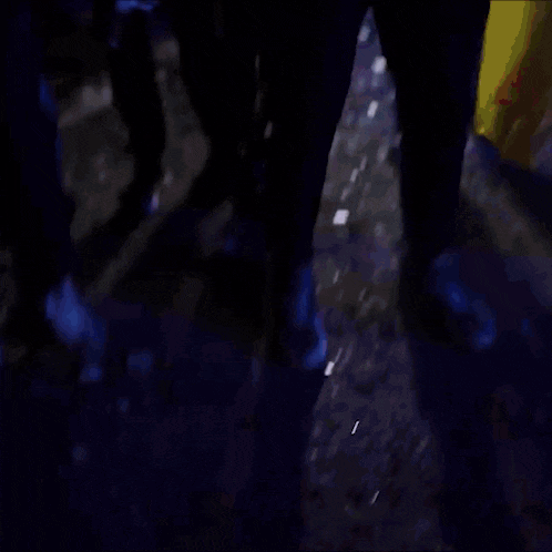a blurry picture of a group of people holding flags in a dark room