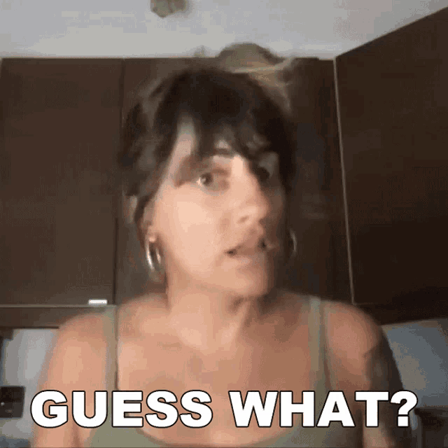 a woman says " guess what " in front of a kitchen