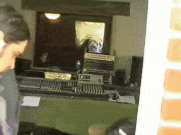 a man is standing in front of a recording studio