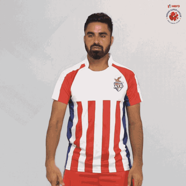 a man wearing a red white and blue striped shirt that says hero on the front