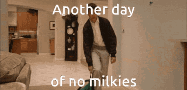 a man carrying a suitcase with the words another day of no milkies on the bottom